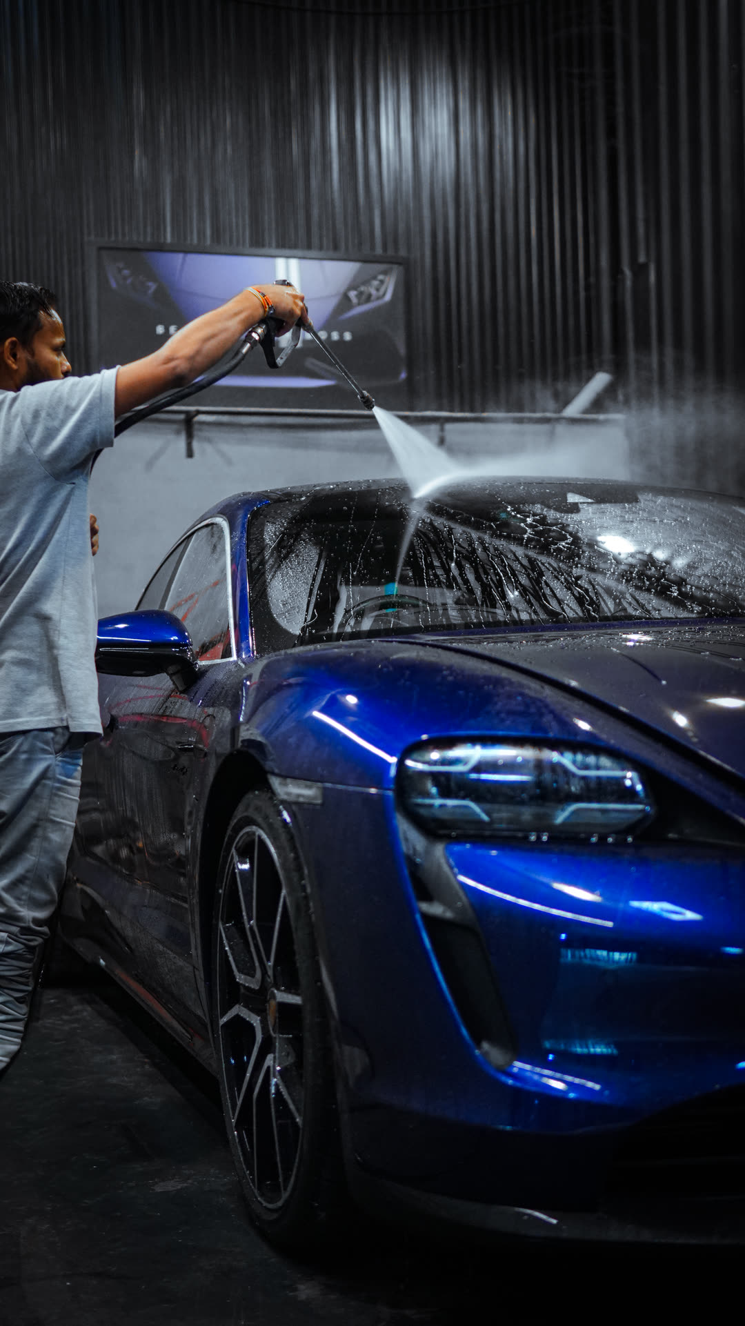 The blue Taycan being washed at check-in